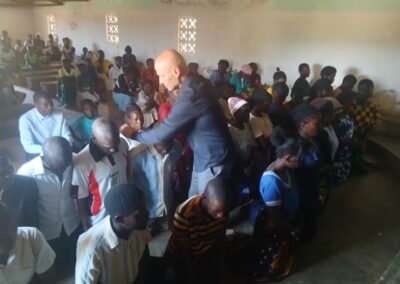 Scotty Sanders prays with 36 people who came forward to accept Christ after preaching at a church in a small village in Malawi